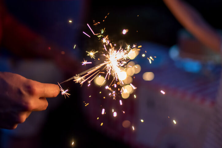 Lighting sparklers in the backyard on a summer evening