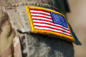 USA flag and US Army patch on solder's uniform