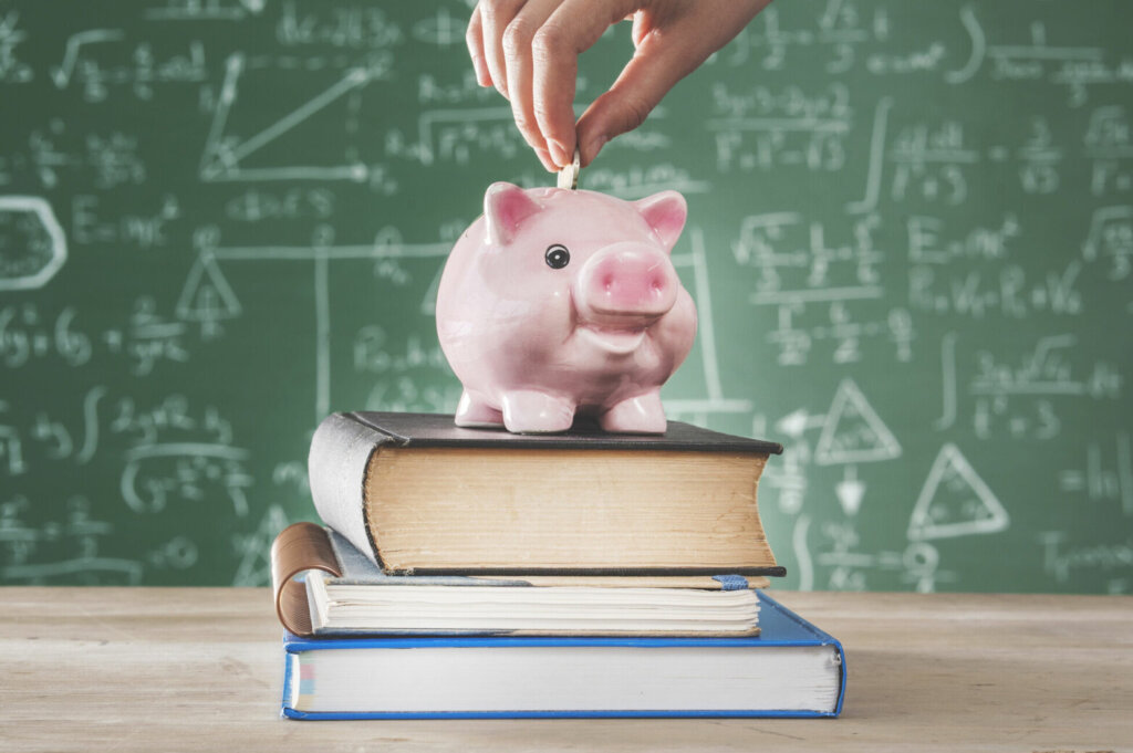 Female putting coin into piggy bank