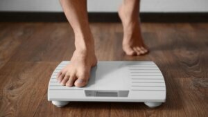 Man,Standing,On,Weight,Scale