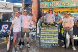 Peter Schultz, second from left, and his team stand with the new state record swordfish. Photo courtesy Big Fish Classic
