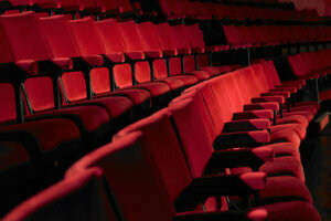 Rows of empty red cinema seats