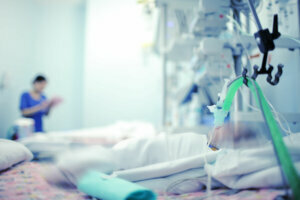 Heavy breathing baby with the help of the apparatus and oxygen in a hospital bed in modern NICU