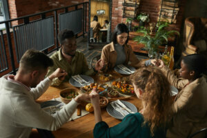 Group of People Praying at Dinner