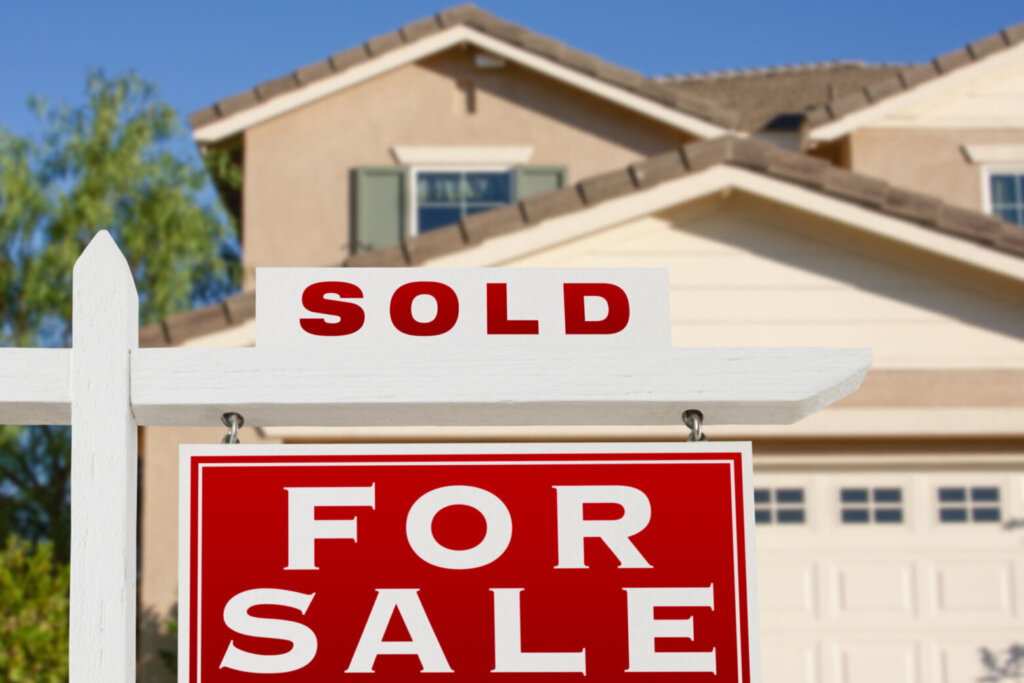Sold Home For Sale Real Estate Sign and House