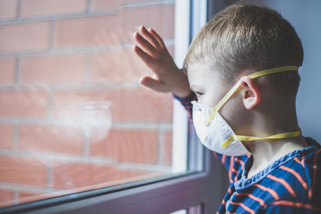 Coronavirus epidemic. Boy with protection mask. Kid in school. Learning, homework, homeschooling, quarantine at home