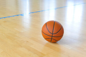 Basketball ball over floor in the gym. Team sport.