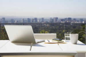 Laptop and paperwork on balcony table
