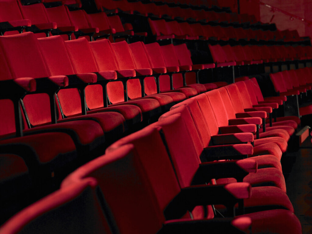 Rows of empty red cinema seats