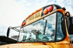 Close Up High Section Of School Bus Against Clouds
