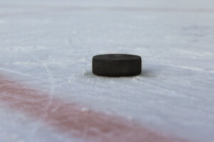 Black hockey puck on a pond