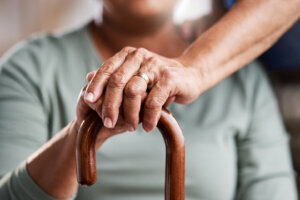 Shot of an unrecognizable senior woman leaning in her walking stick at home