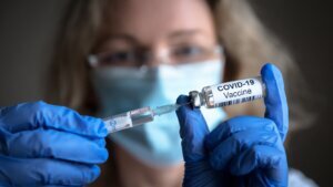 Covid 19,Vaccine,In,Researcher,Hands,,Female,Doctor,Holds,Syringe,And