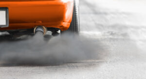 Air pollution crisis in city from diesel vehicle exhaust pipe on road