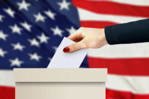Women hand casting a vote