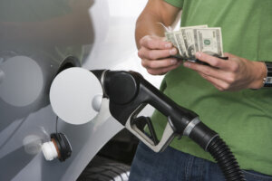 Young man with fuel pump, mid section