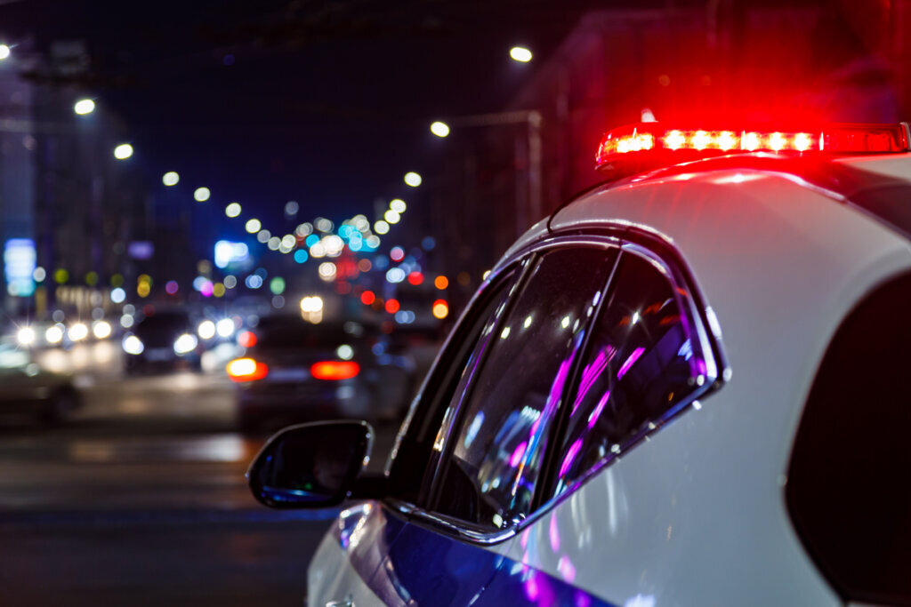 Police car lights in night city with selective focus and bokeh