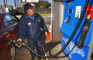 Station attendant, George Samaniego, pumps gas at an Exxon g