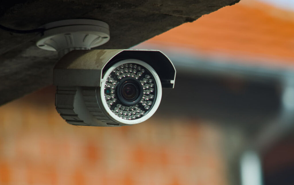 Surveillance security camera under the concrete wall of the building