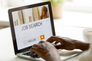 African american man browsing work online using job search computer app