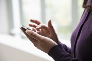 Hispanic woman using cell phone