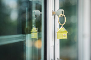 House model and key in house door. Real estate agent offer house, property insurance and security, affordable housing concepts