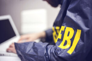 Policeman using laptop in office