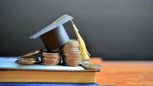 Hat,Graduation,Model,On,Money,Coins,Saving,For,Concept,Investment