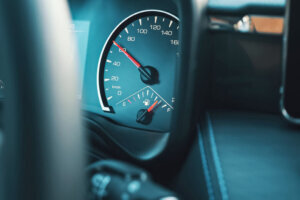 Red arrow on dashboard speedometer shows speed increase