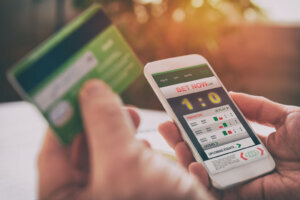 Man betting on sports with smartphone