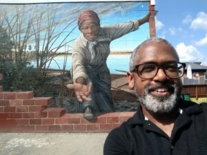 Tony Cohen of the Menare Foundation in front of Harriet Tubman mural