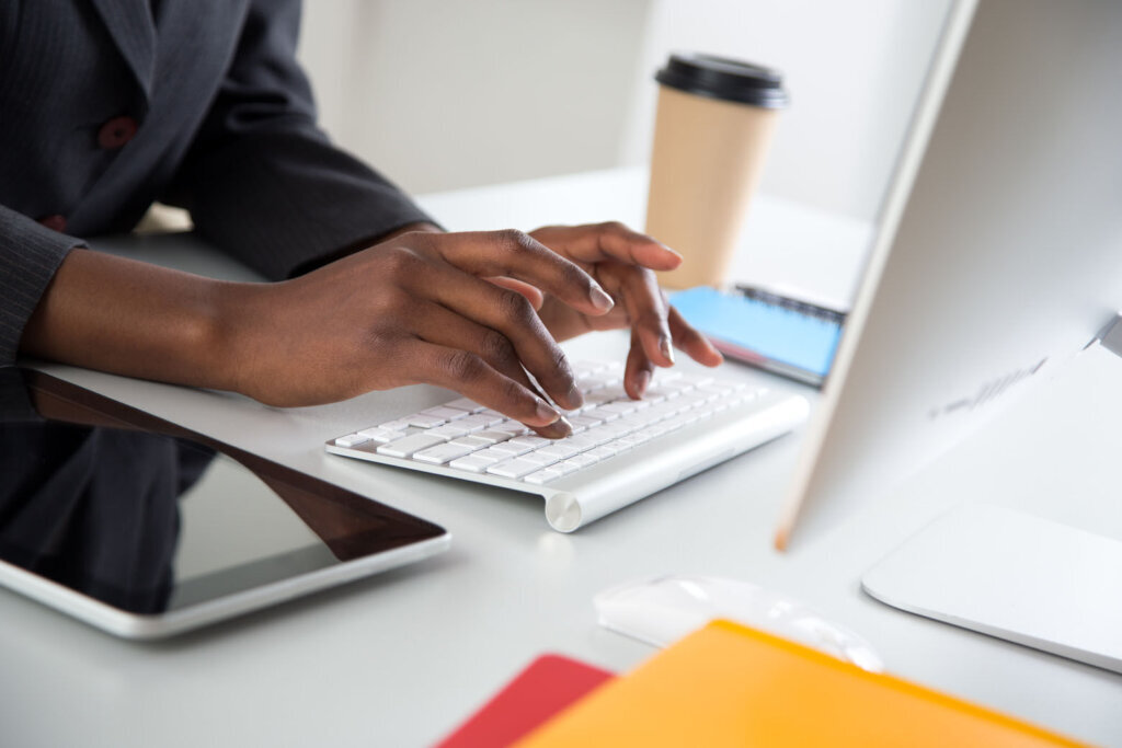 Close up of hands of african american businesswoman typing on a laptop.