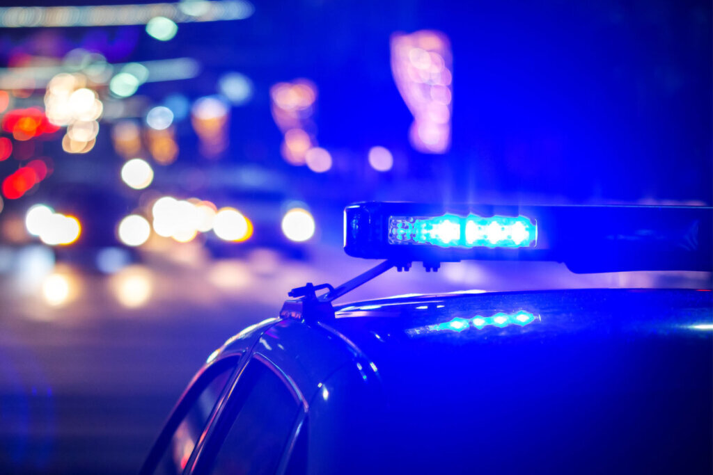 Night police car lights in city close up with selective focus and bokeh