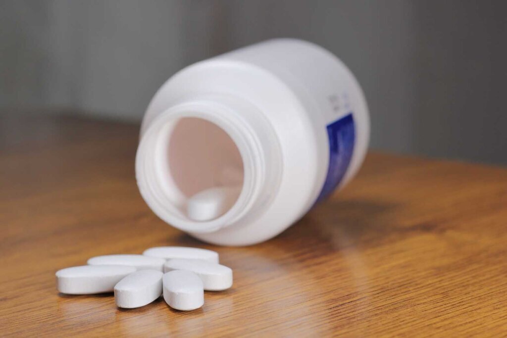 Anti Radiation Pills, Iodine tablets, tablets for radiation protection on the wooden table with a white medical jar