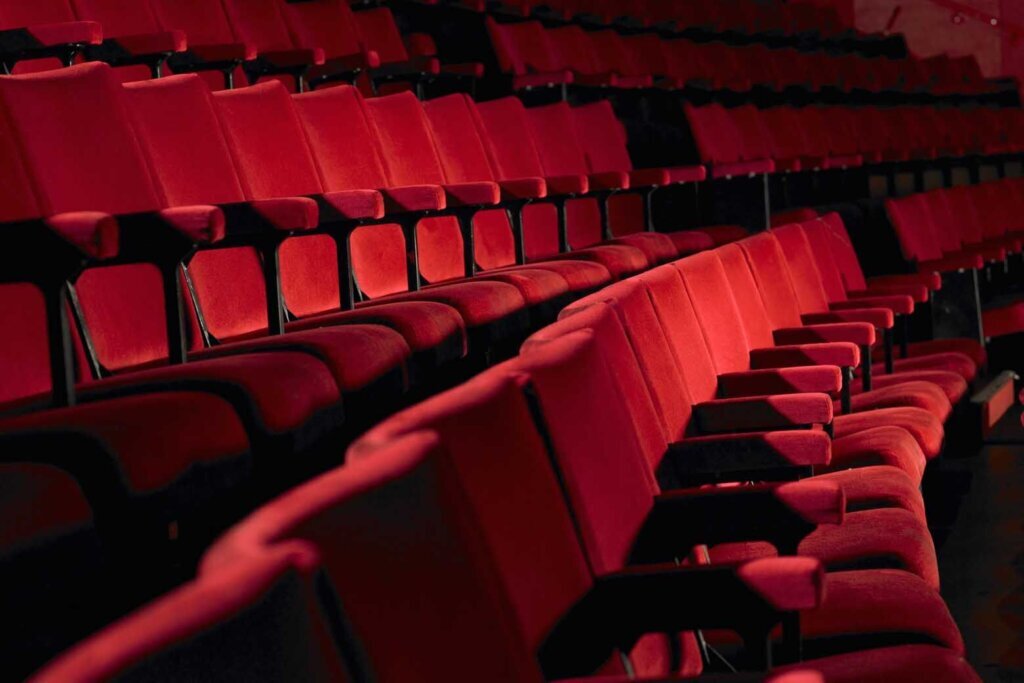 Rows of empty red cinema seats