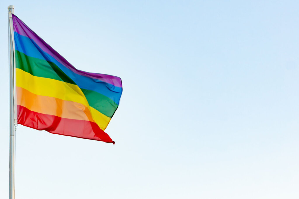 Lgbti concept: lgbt rainbow flag on a pole waving in the wind