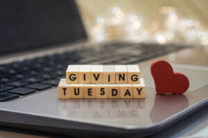 GIVING TUESDAY letter blocks concept on laptop keyboard