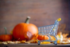 Maple leaves and pumpkins with supermarket cart