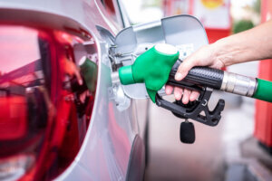 Woman's hand filling fuel into the car tank at the pump service station, for concept transportation power business rising prices inflation