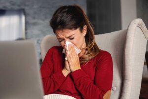 Sick,Woman,Sitting,In,Chair,At,Home,During,Lockdown,With