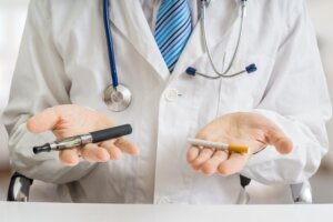 Doctor is comparing electronic vaporizer and conventional tobacco cigarette.