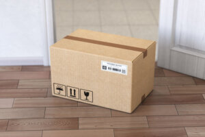 Delivery service concept.. Cardboard box front of entrance open door.