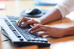 Close up of female hands typing on keyboard