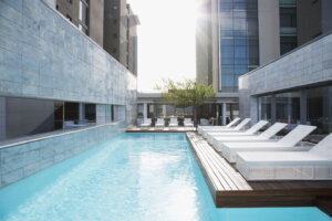 Modern lounge chairs next to swimming pool