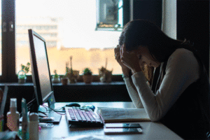 Businesswoman frustrated by bad new at office desk