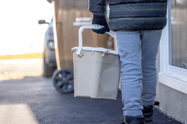 Little Boy Composting at Home and Bringing Food Waste to Composting Bin