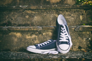 Pair of new sneakers on a stone stairs. Canvas shoes.