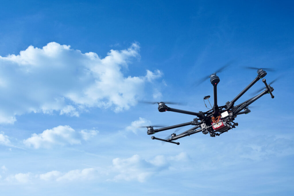 Drone flying through blue sky. (Courtesy Getty Images)