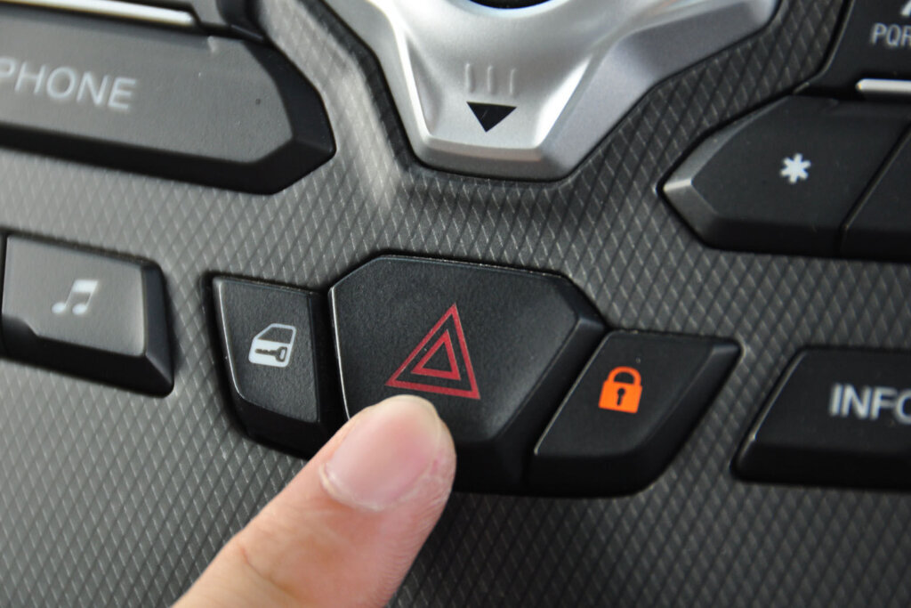 Person turning car hazard lights on. (Courtesy Getty Images)