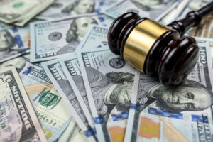 Judge gavel and 100 dollar bills as background